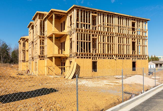 a temporary chain link fence winding around a construction site, outlining the project's progress in Des Plaines IL